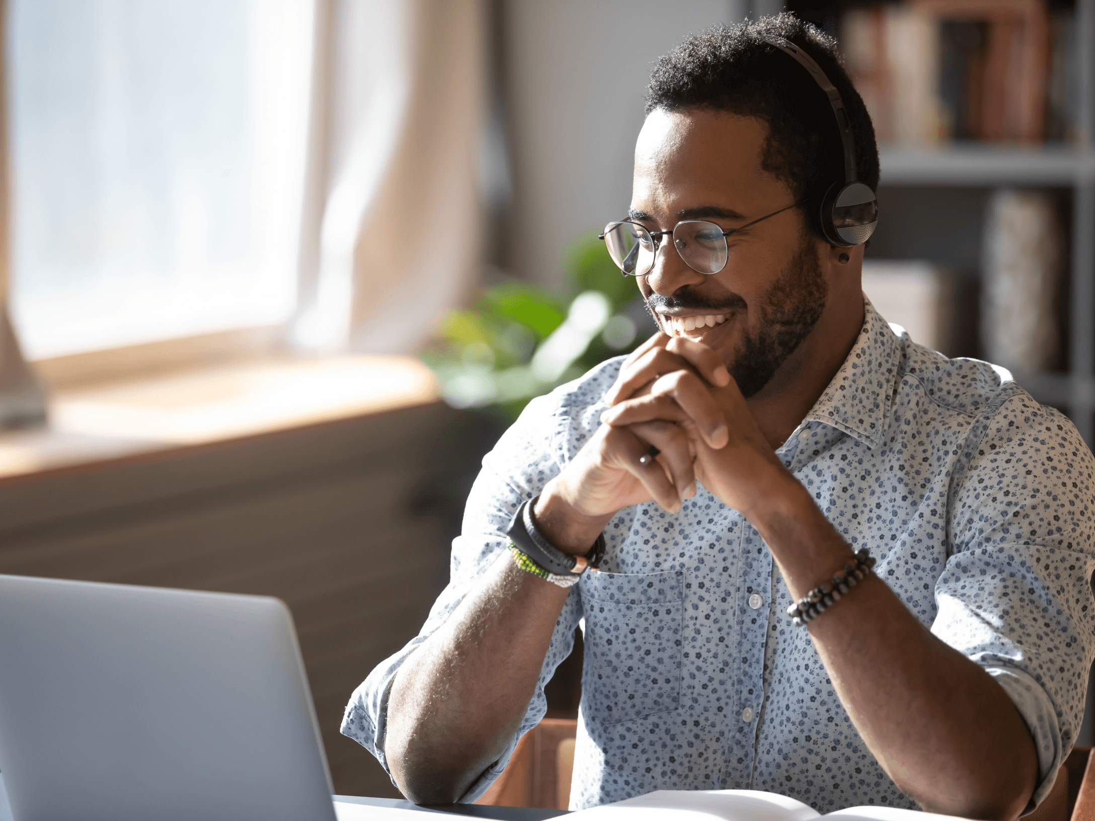 person smiling at laptop