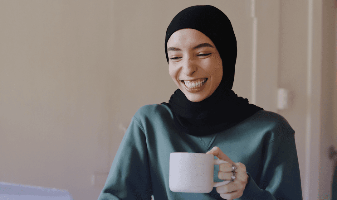 woman smiling wide with mug